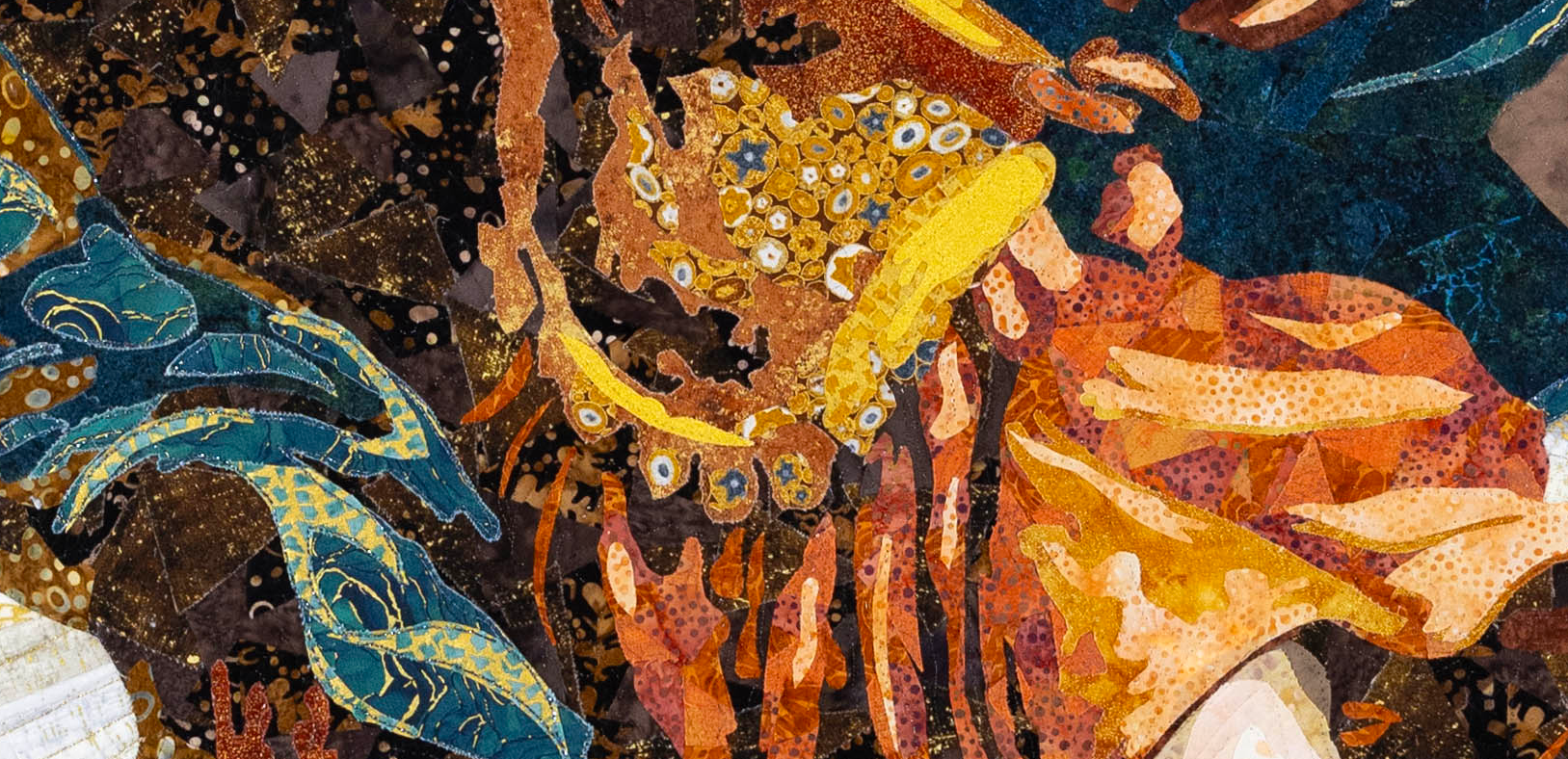 Close-up of layered turquoise, gold, rust, and dark patterned fabrics in the Archangel art quilt.